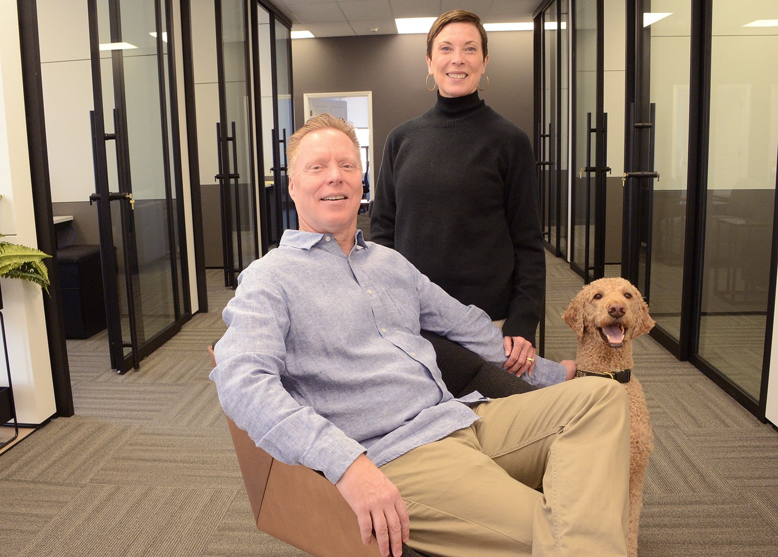 Dan Bullis and his wife Dorothy Rogers-Bullis with their dog Risely, in their Congress Springs coworking space for Saratoga CoWorks